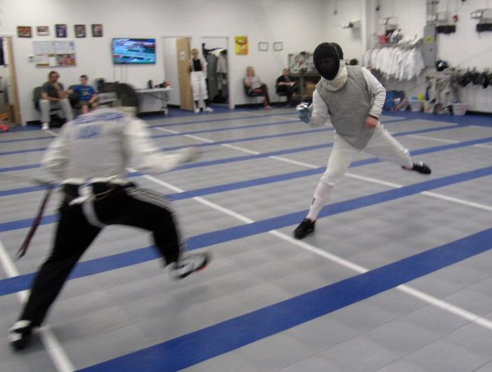 Adult foil and saber fencers practicing during Open Fencing at Fencing Academy of Boston in Watertown MA